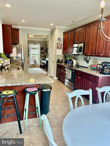 a view of a livingroom with furniture and a kitchen