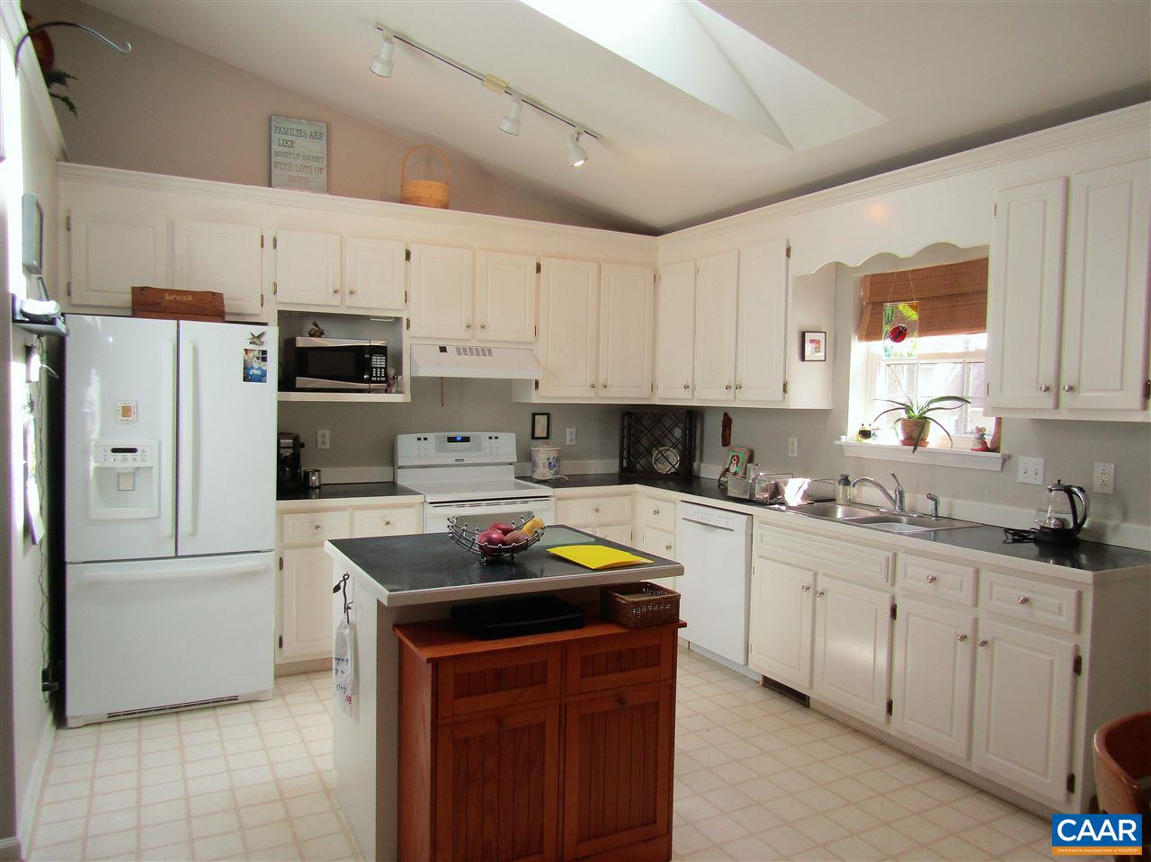 44 Amethyst Road Palmyra, VA 22963 - Photo 3 of 23 a kitchen with stainless steel appliances granite countertop a sink stove refrigerator and white cabinets with wooden floor