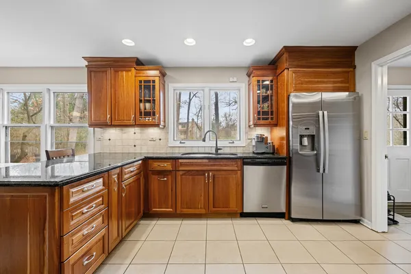 a kitchen with stainless steel appliances granite countertop a refrigerator and a sink