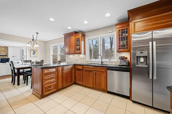 a kitchen with stainless steel appliances granite countertop a refrigerator and a sink