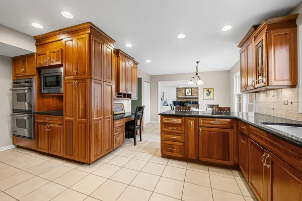 a kitchen with stainless steel appliances granite countertop a refrigerator and a sink