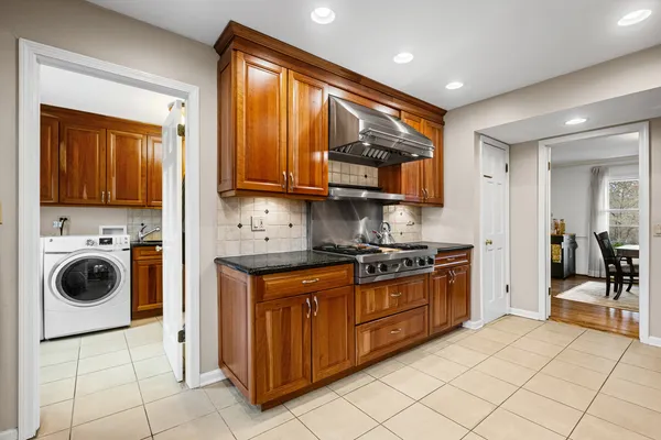 a kitchen with stainless steel appliances granite countertop a stove and a sink