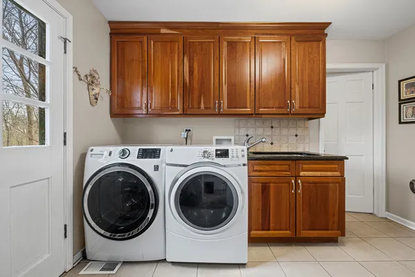 a utility room with sink dryer and washer