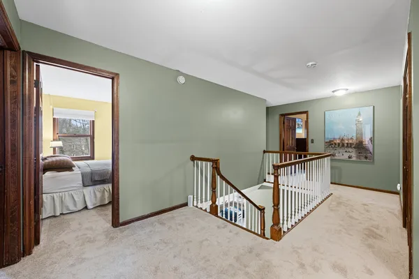 a view of a hallway with bedroom and balcony