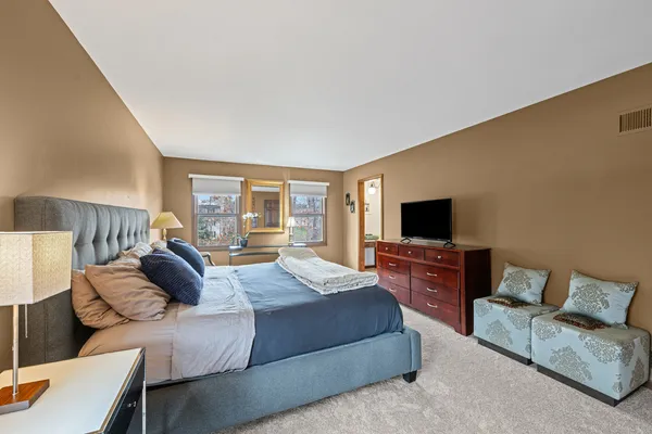 a bedroom with a bed and couch