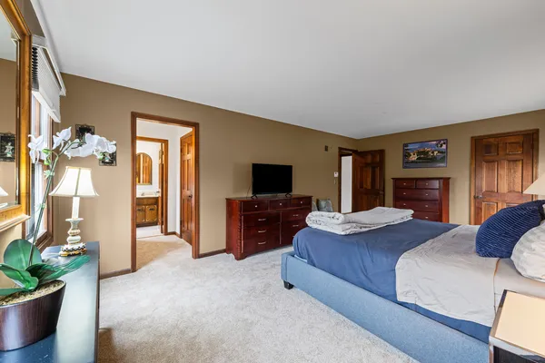 a bedroom with a bed and a flat screen television