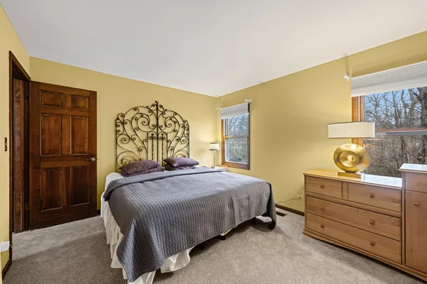 a bedroom with a bed and cabinet