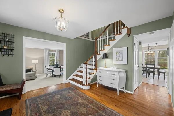 a view of an entryway with wooden floor windows and a livingroom