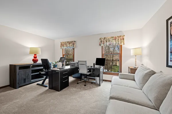 a view of a livingroom with workspace and a couch