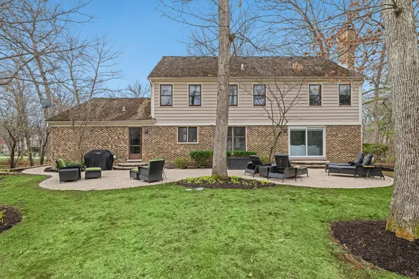 a front view of a house with patio and garden