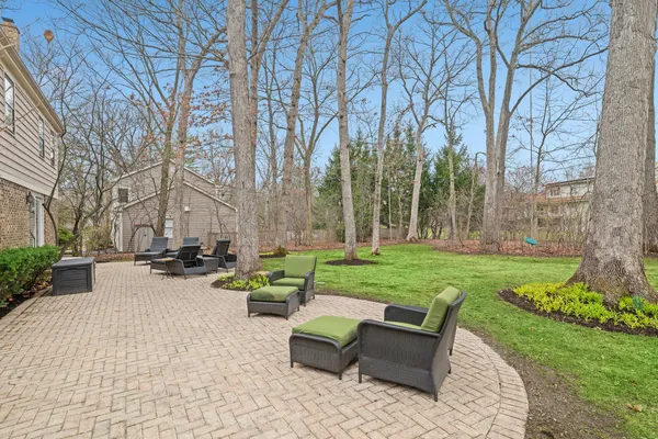 a view of a patio with couches and table and chairs next to yard