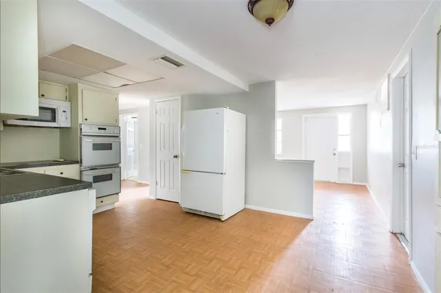 a view of a kitchen with a sink and a refrigerator