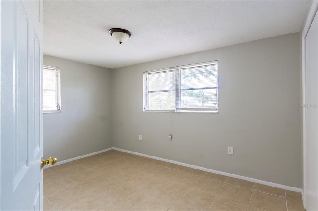 7735 Rottingham Road Port Richey, FL 34668 - Photo 16 of 24 an empty room with windows