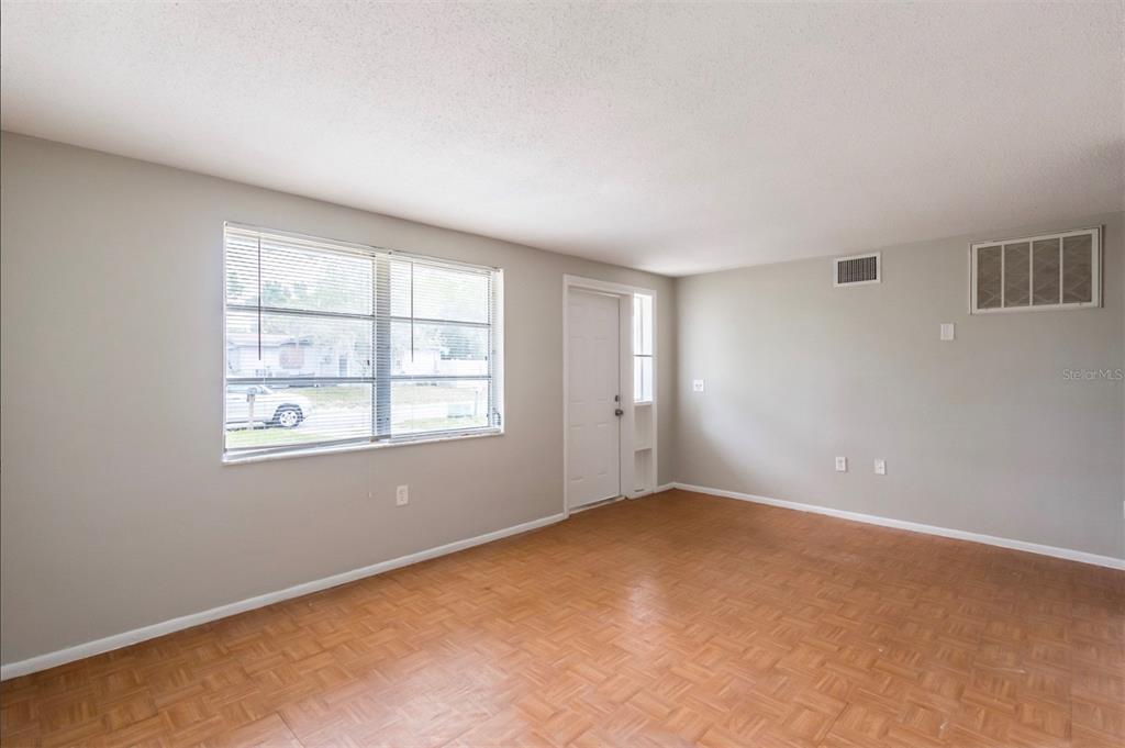 7735 Rottingham Road Port Richey, FL 34668 - Photo 3 of 24 an empty room with windows