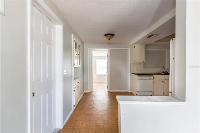 a hallway with sink and mirror