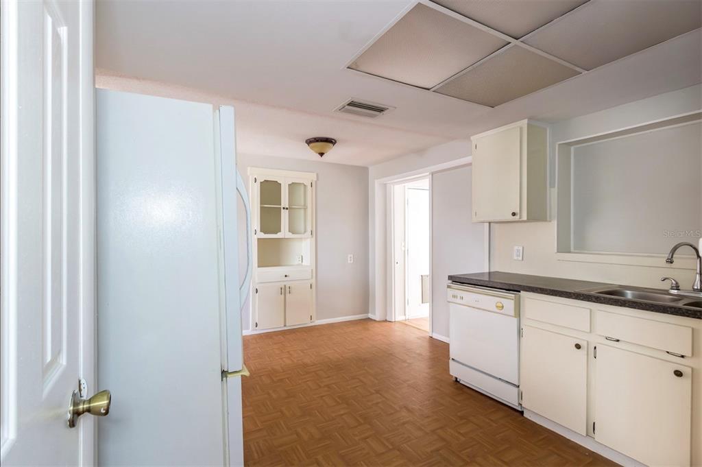 7735 Rottingham Road Port Richey, FL 34668 - Photo 7 of 24 a view of a kitchen with white cabinets
