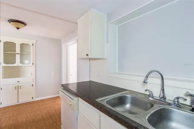 a kitchen with a sink and cabinets