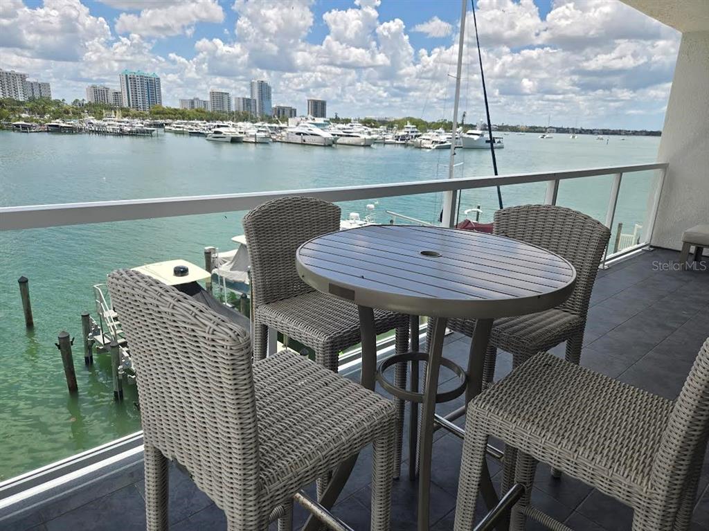650 Golden Gate Point, Unit 301 Sarasota, FL 34236 - Photo 29 of 31 a balcony with table and chairs