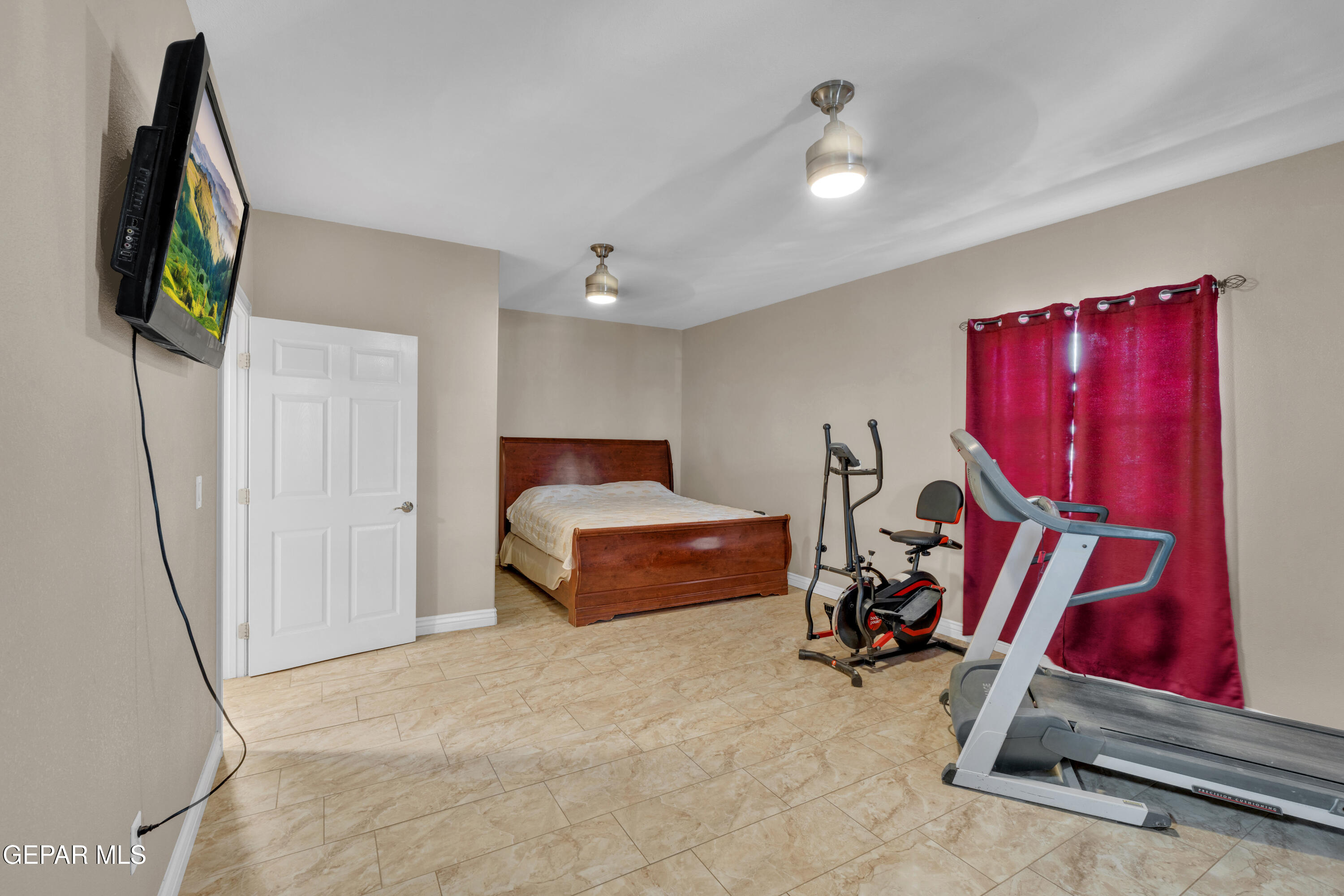 5378 Krag Street El Paso, TX 79938 - Photo 21 of 63 a bedroom with furniture and a flat screen tv