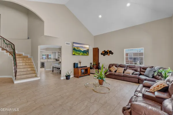 a living room with furniture and stairs