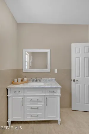a kitchen with granite countertop a refrigerator and a stove top oven