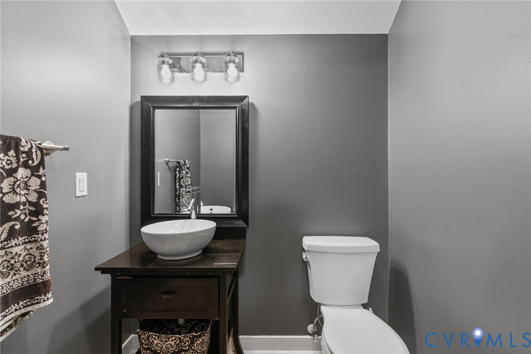 1755 Dispatch Road Quinton, VA 23141 - Photo 56 of 86 a bathroom with a toilet a sink and a mirror