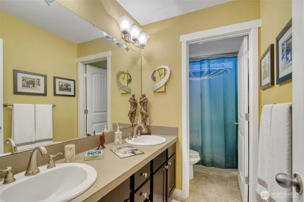 a bathroom with a double vanity sink and a mirror