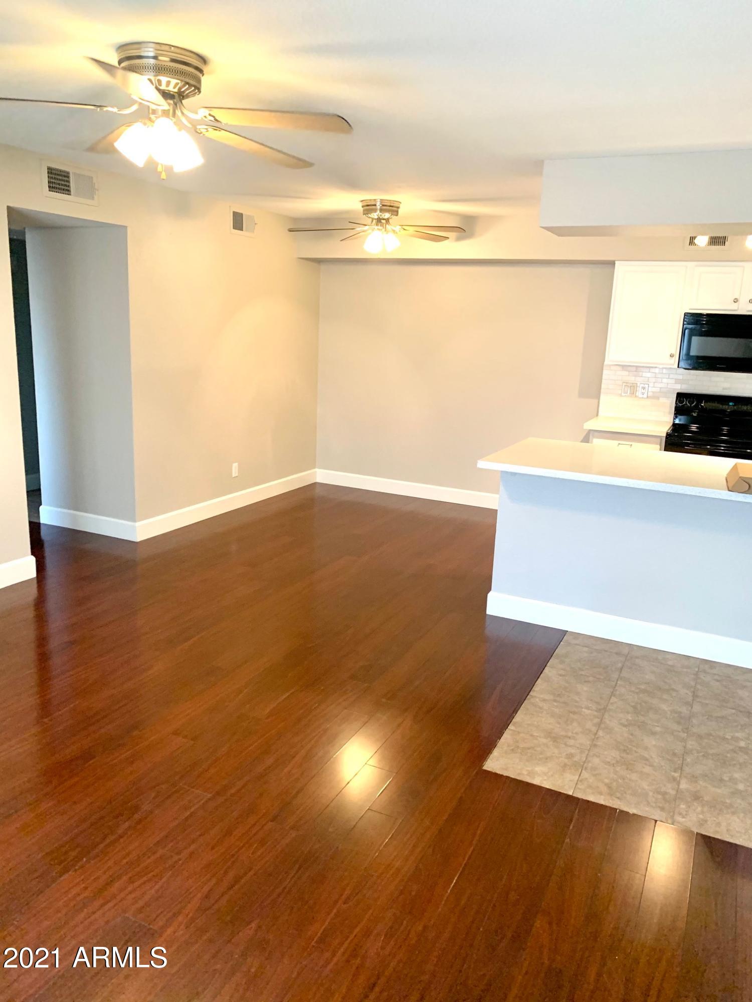 2625 East Indian School Road, Unit 101 Phoenix, AZ 85016 - Photo 4 of 15 a view of kitchen and wooden floor