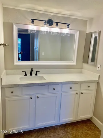 a bathroom with a sink and a mirror