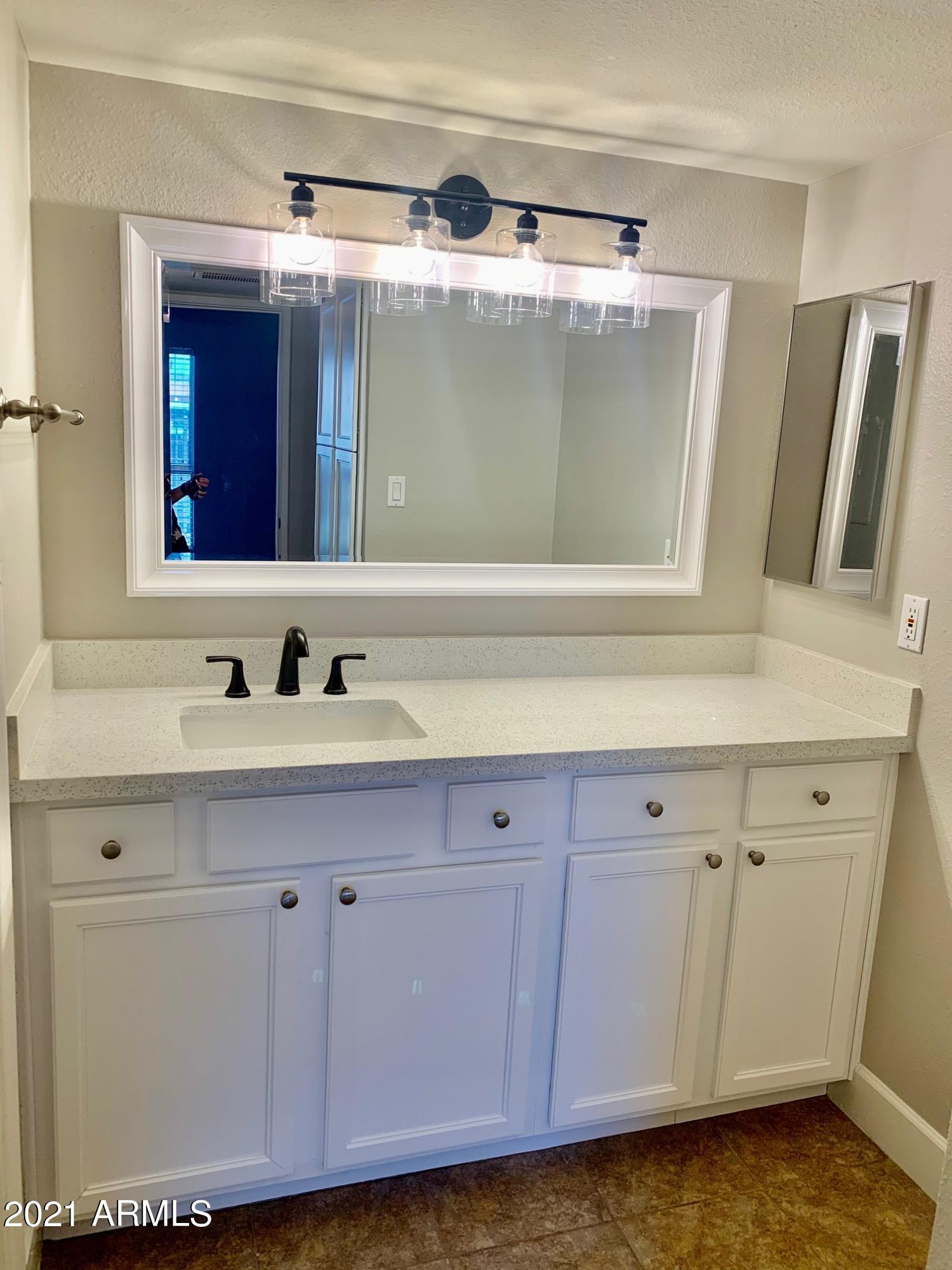 2625 East Indian School Road, Unit 101 Phoenix, AZ 85016 - Photo 5 of 15 a bathroom with a sink and a mirror