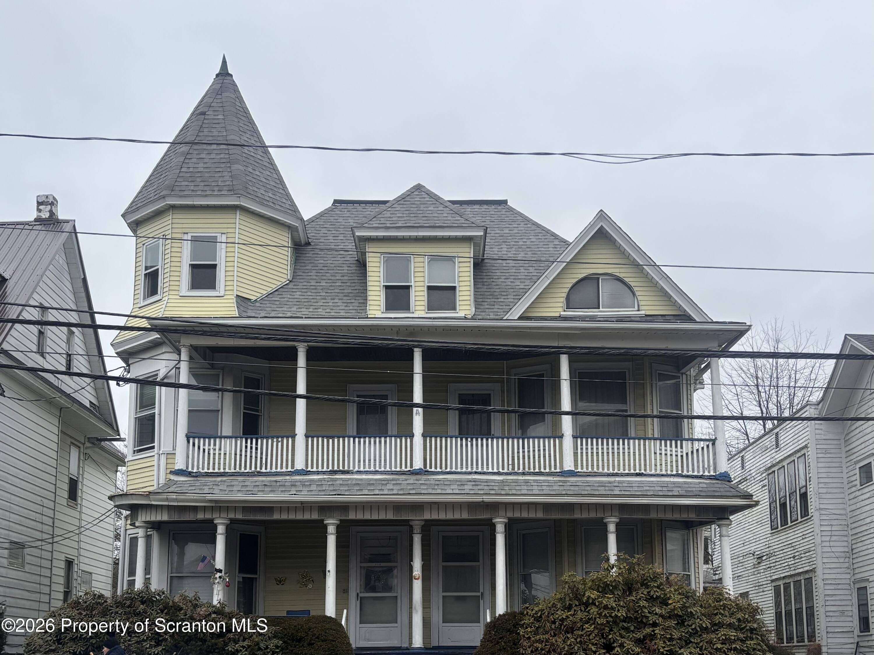 218 South Main Avenue Scranton, PA 18504 - Photo 1 of 9 a view of a white house with large windows and a small yard