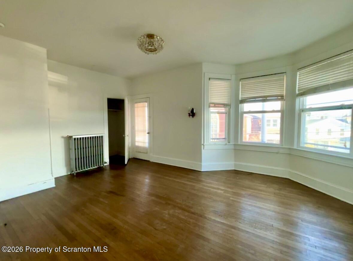 218 South Main Avenue Scranton, PA 18504 - Photo 2 of 9 a view of an empty room with wooden floor and a window