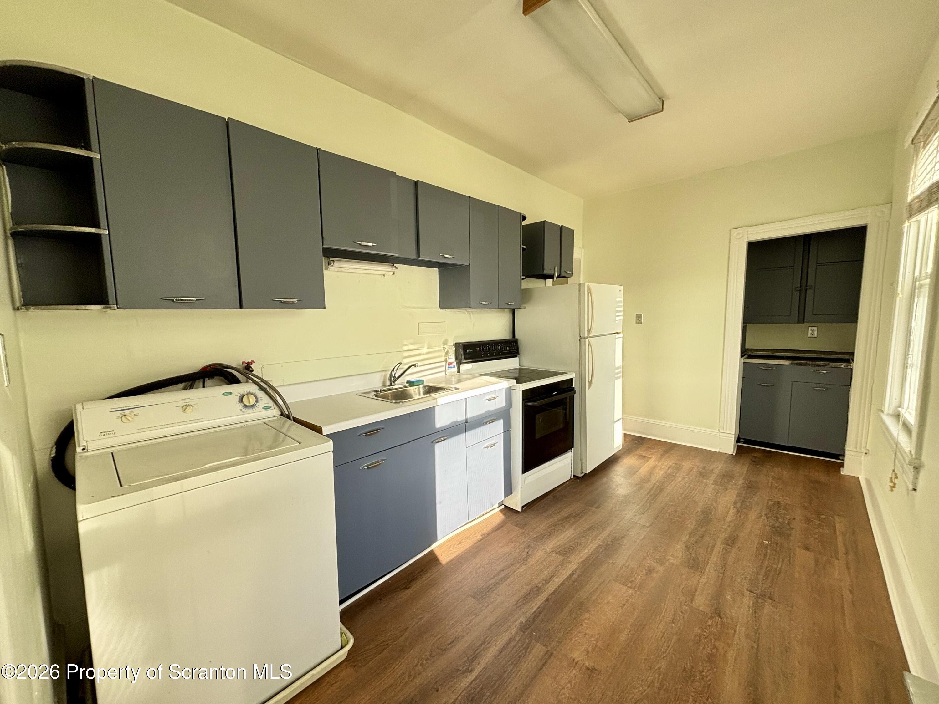 218 South Main Avenue Scranton, PA 18504 - Photo 6 of 9 a view of a kitchen with a sink and a refrigerator