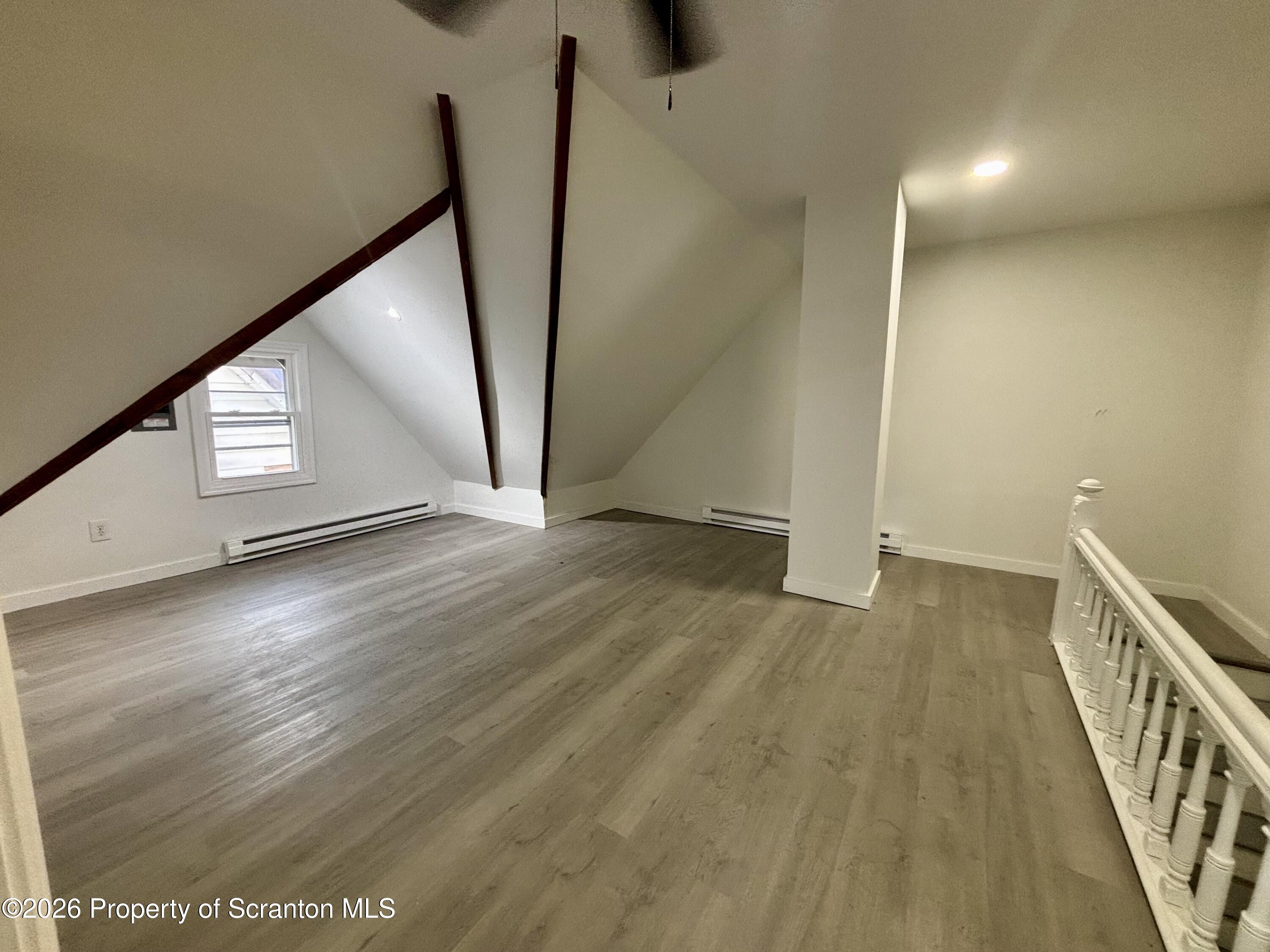 218 South Main Avenue Scranton, PA 18504 - Photo 8 of 9 a view of an empty room with wooden floor and stairs