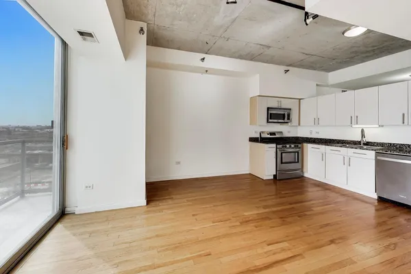 a kitchen with stainless steel appliances granite countertop a refrigerator and a stove