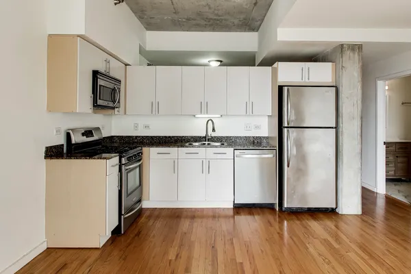 a kitchen with a refrigerator and a stove