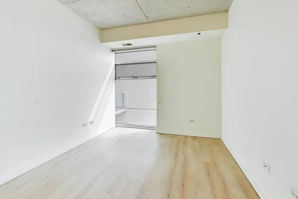 an empty room with wooden floor and closet