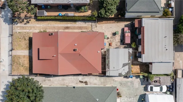 an aerial view of a house with yard and seating space