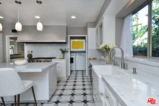 a spacious bedroom with a bed and a large window