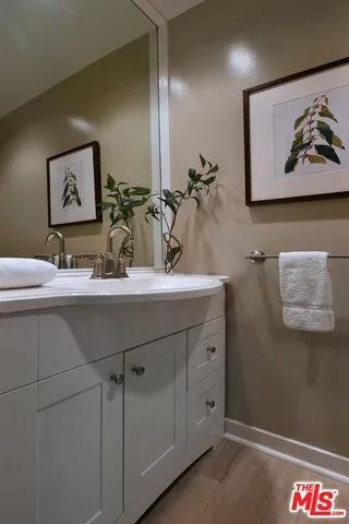 a bathroom with a sink a mirror and a shower