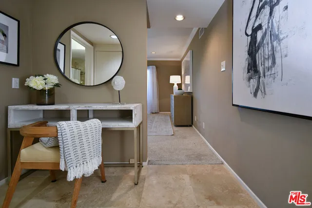 a bedroom with a bed and wall painting