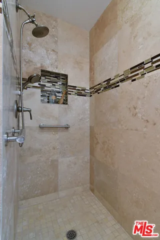 a view of a backyard with plants and a fountain