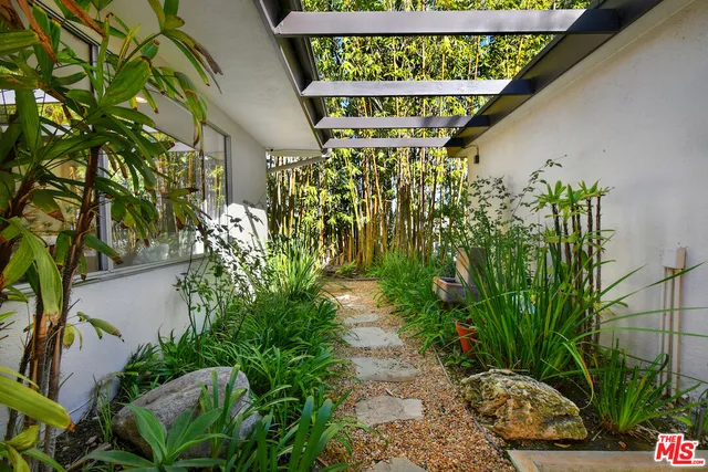 a living room with furniture fireplace and a large window