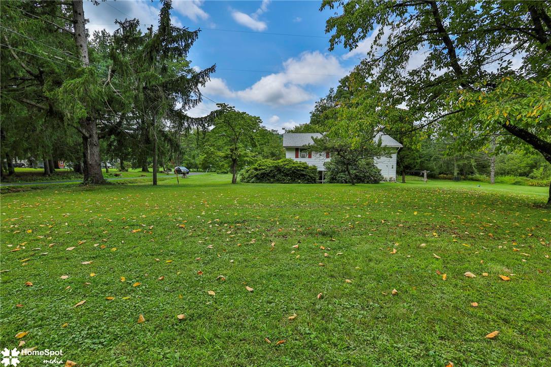6054 Old Hickory Road Coopersburg, PA 18036 - Photo 41 of 48 Mature trees frame a sprawling grassy lawn leading toward the home.