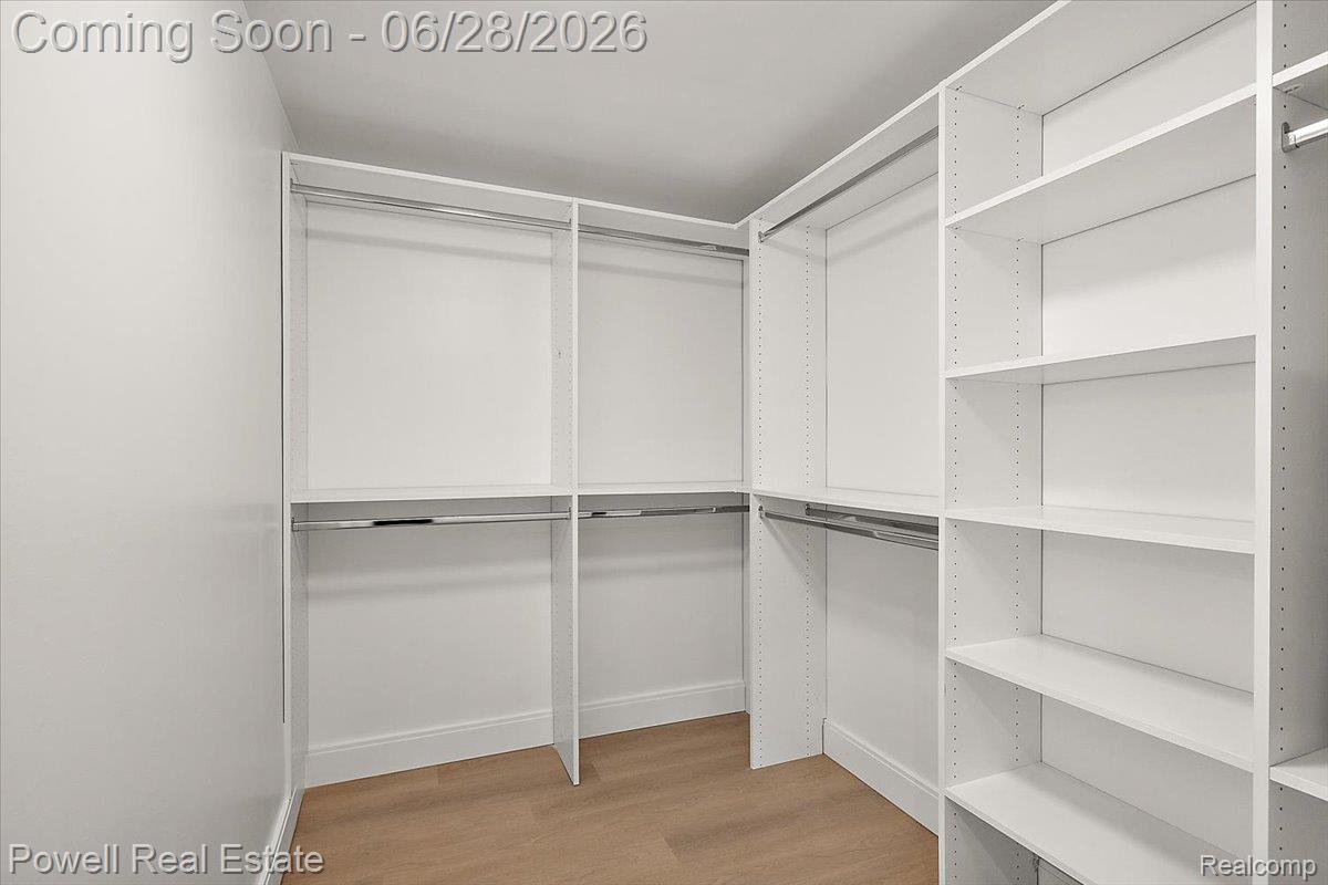1447 Ravineview Court, Unit C12 Bloomfield Hills, MI 48304 - Photo 33 of 49 Custom closet system featuring white shelving and chrome hanging rods