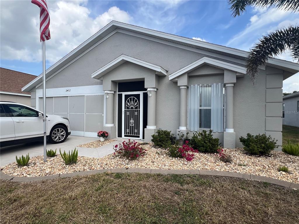 24472 Manchester Trail Punta Gorda, FL 33980 - Photo 1 of 46 a front view of a house with a yard