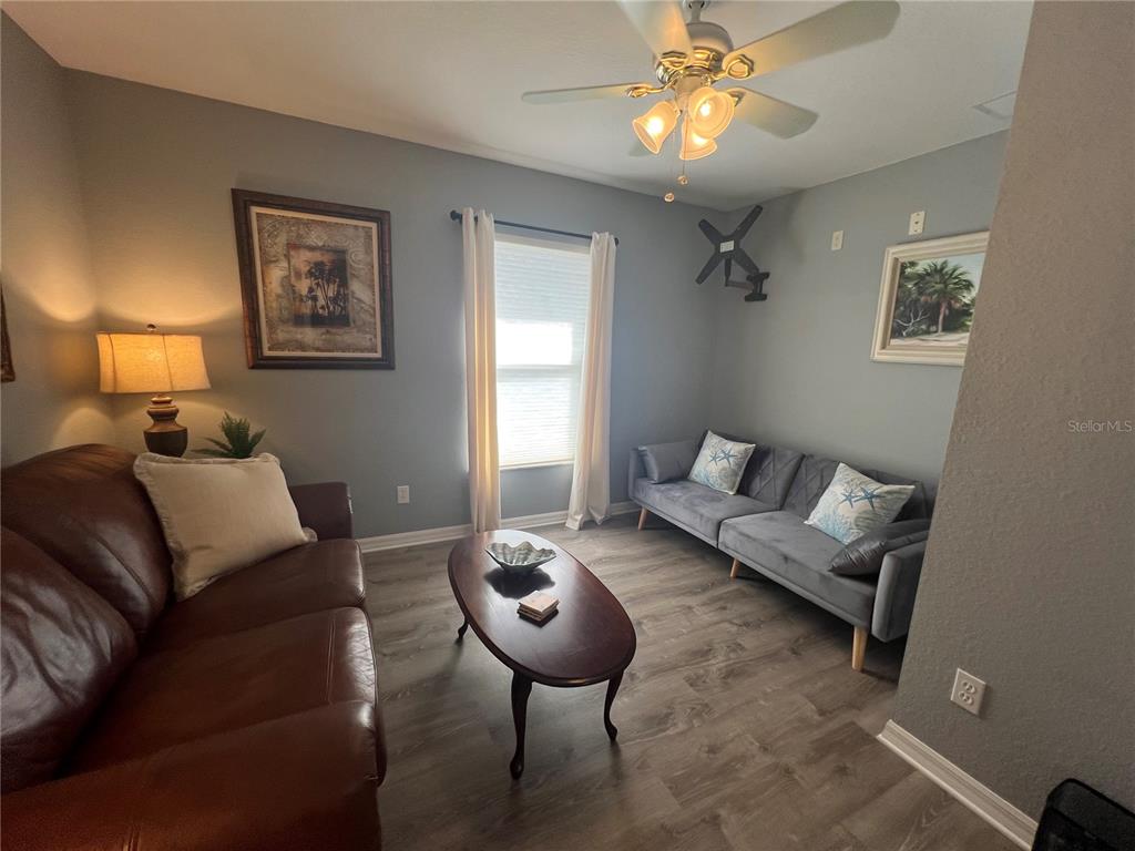 24472 Manchester Trail Punta Gorda, FL 33980 - Photo 13 of 46 a living room with furniture a chandelier and a window