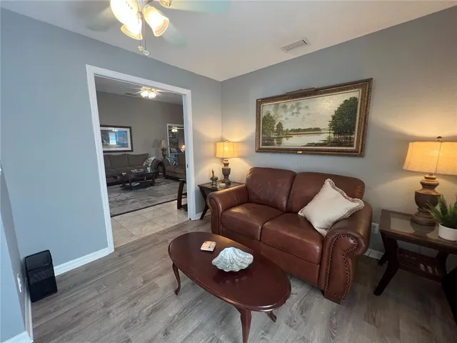 a living room with furniture and a wooden floor