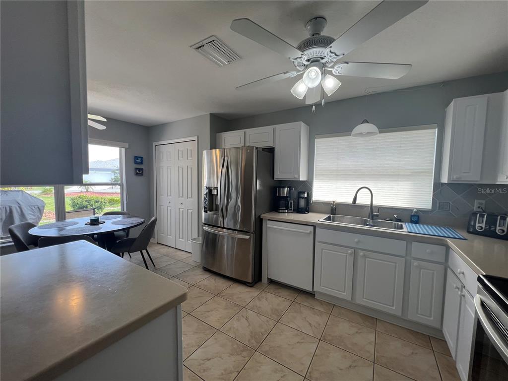 24472 Manchester Trail Punta Gorda, FL 33980 - Photo 16 of 46 a kitchen with a cabinets and chandelier