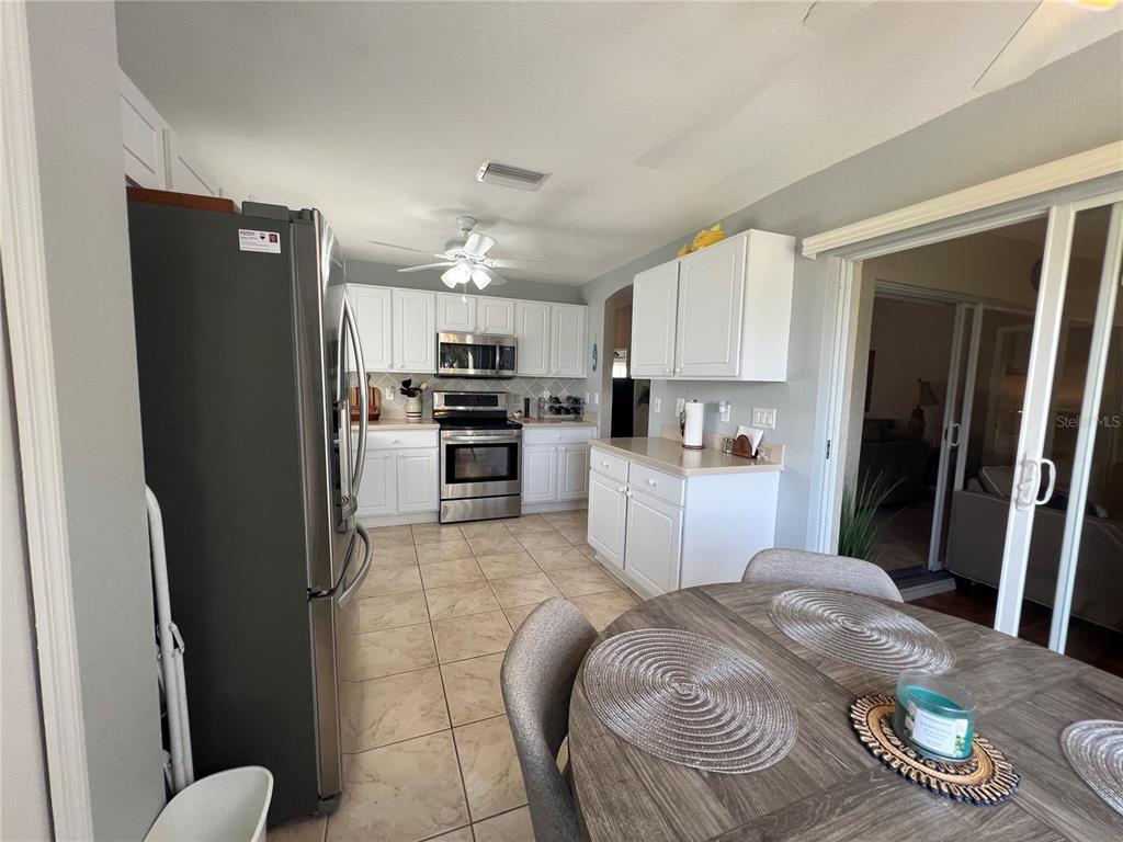 24472 Manchester Trail Punta Gorda, FL 33980 - Photo 18 of 46 a kitchen with stainless steel appliances granite countertop a refrigerator sink and stove